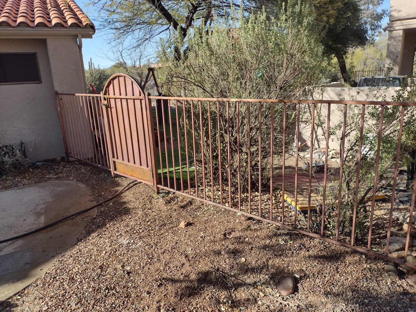 Arched iron garden gate — Emery Welding & Ironwork