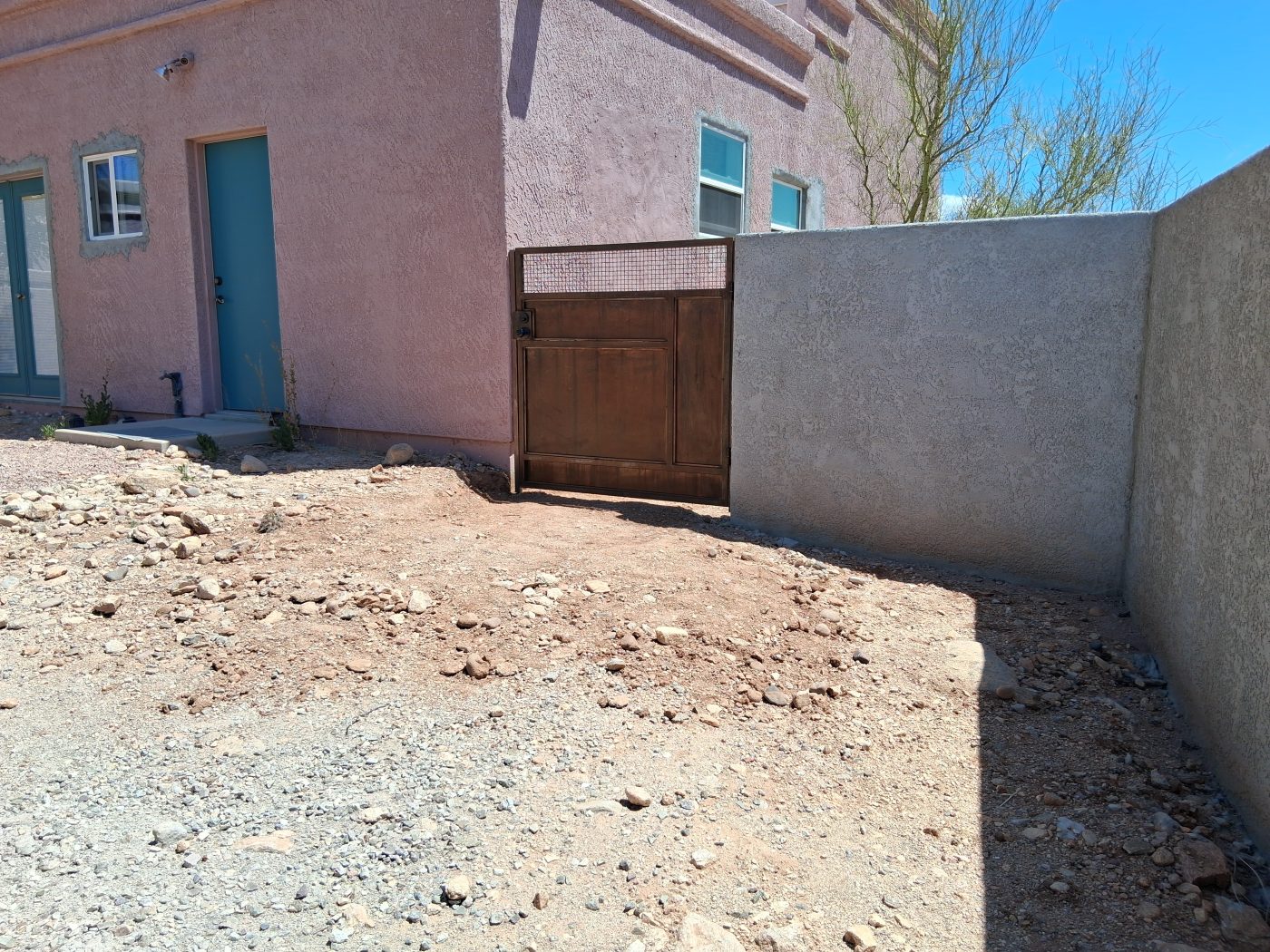 Block wall with steel gate — Emery Welding & Ironwork
