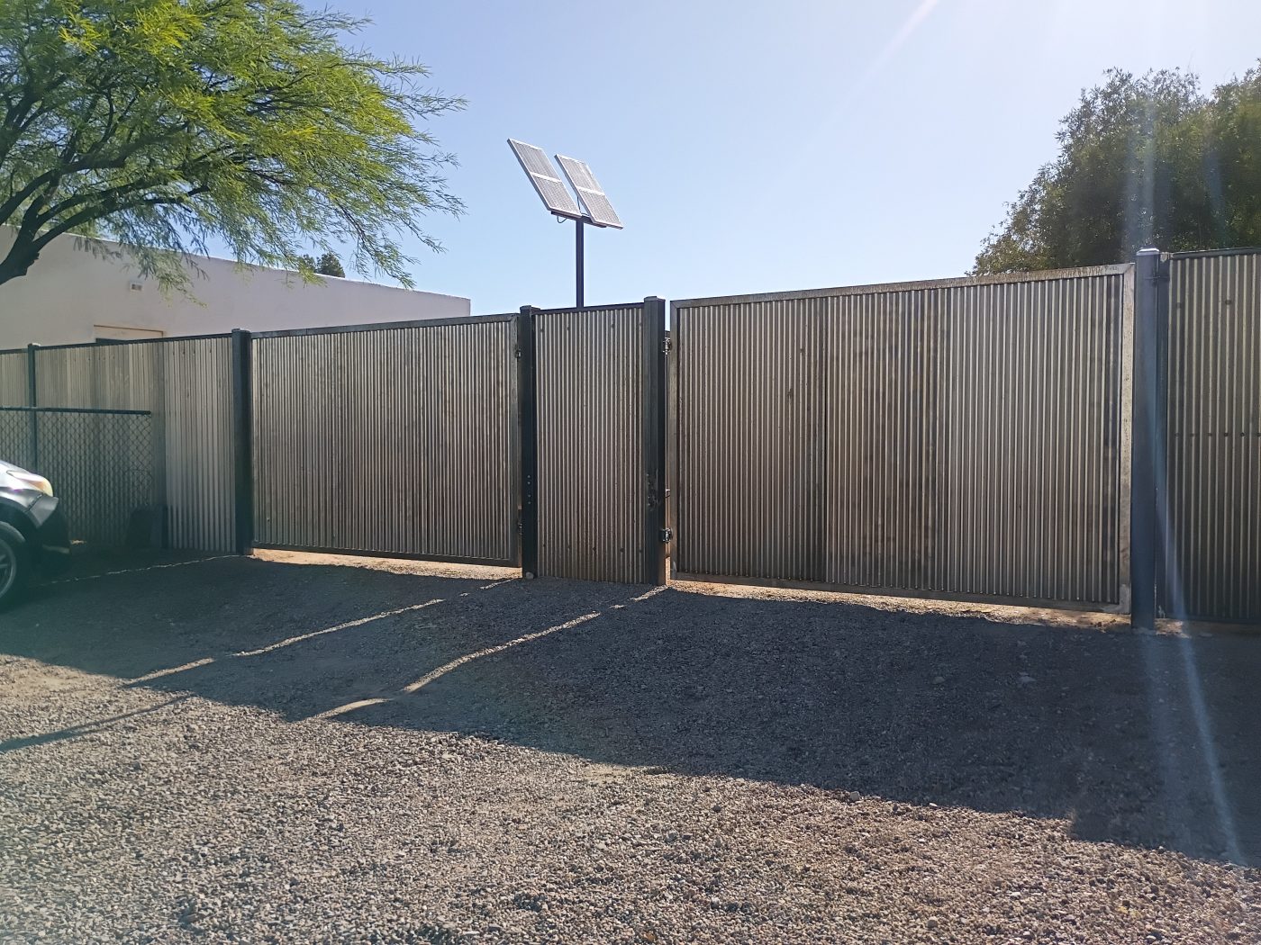 Corrugated metal fence side yard — Emery Welding & Ironwork