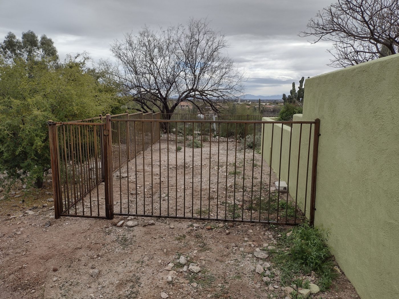 Steel security gate stucco wall — Emery Welding & Ironwork