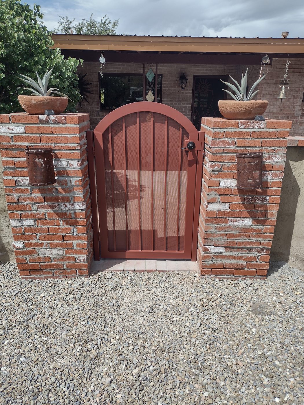 Wood and iron arched entry gate brick columns — Emery Welding & Ironwork